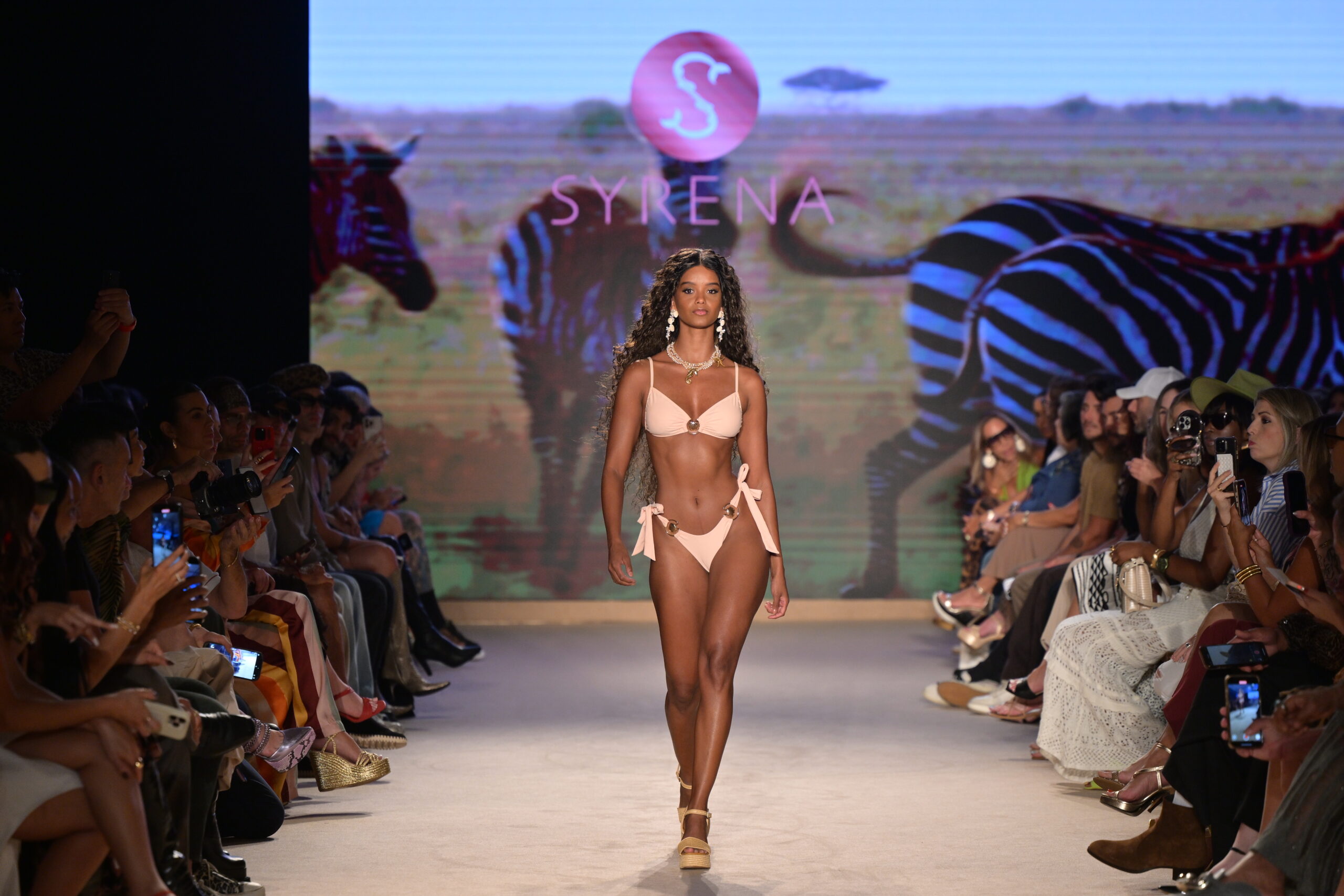 Carolina Londoño Mejia walking in Syrena Swimwear’s ‘Walk for Wildlife’ runway show, set against a striking savanna backdrop, at Paraiso Miami Swim Week 2025 – Photo by Simon Soong, courtesy of Paraiso and Miami Swim Week
